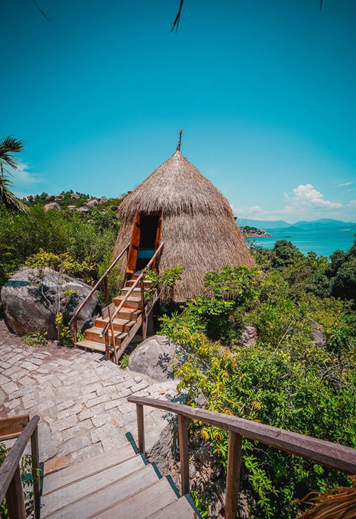 Bird's nest tent and stone cave house on the shore of Cam Ranh Bay