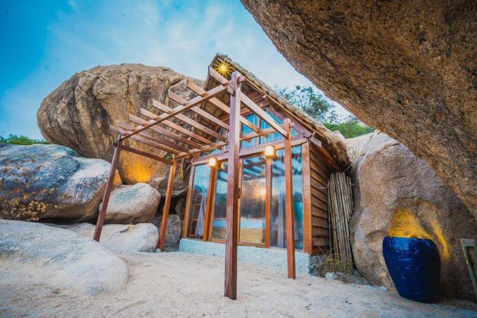Bird's nest tent and stone cave house on the shore of Cam Ranh Bay